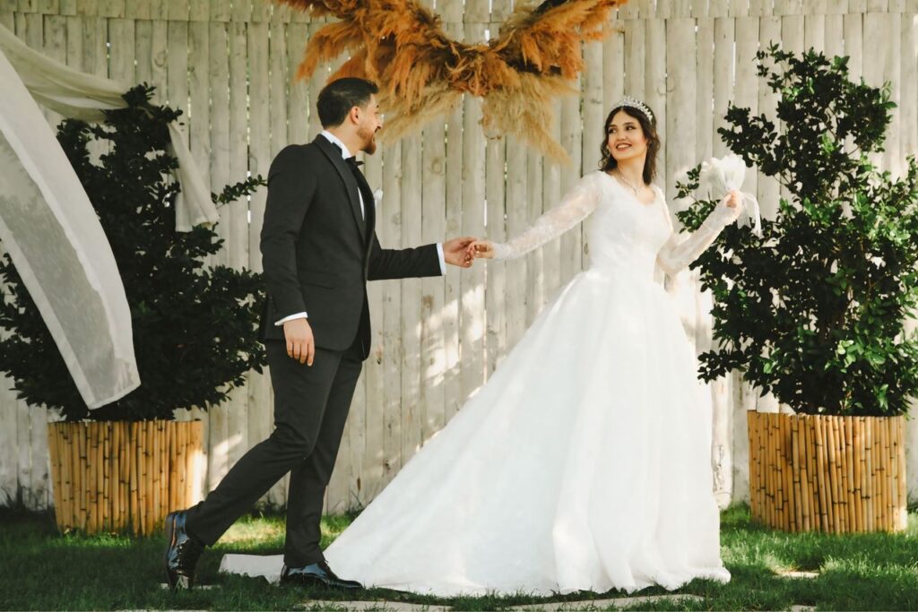 Mastering the First Impression: Your intriguing post title goes here A bride and groom share a joyful moment outdoors at their elegant wedding.